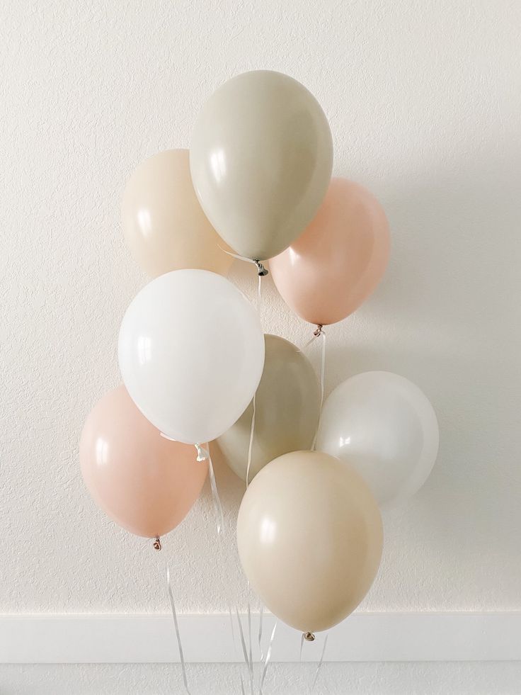 a bunch of balloons that are in the air with some string attached to one of them