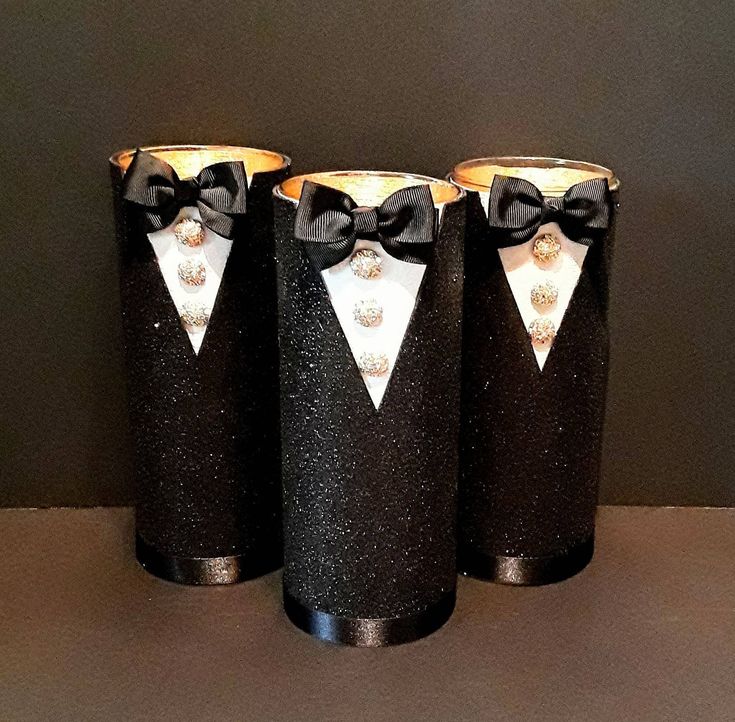 three black canisters with white and silver bow ties