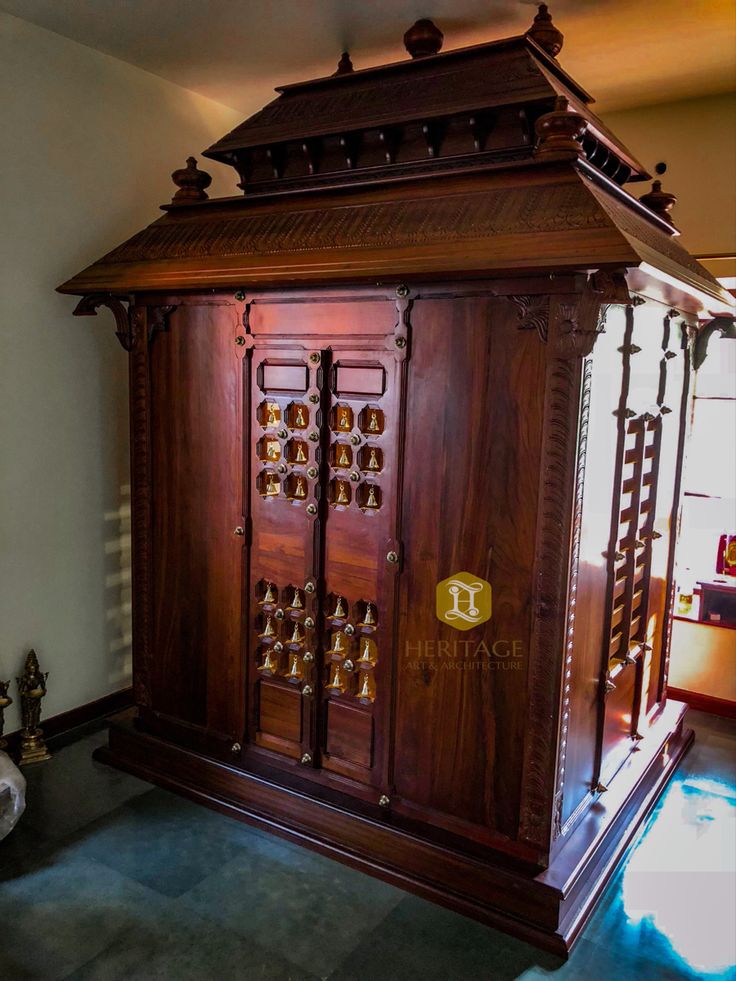 an ornate wooden cabinet in the corner of a room