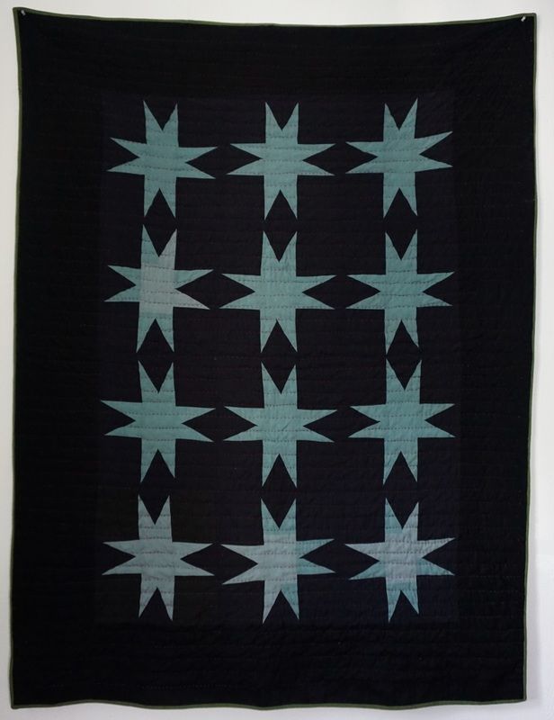 a black and white quilt with stars on it