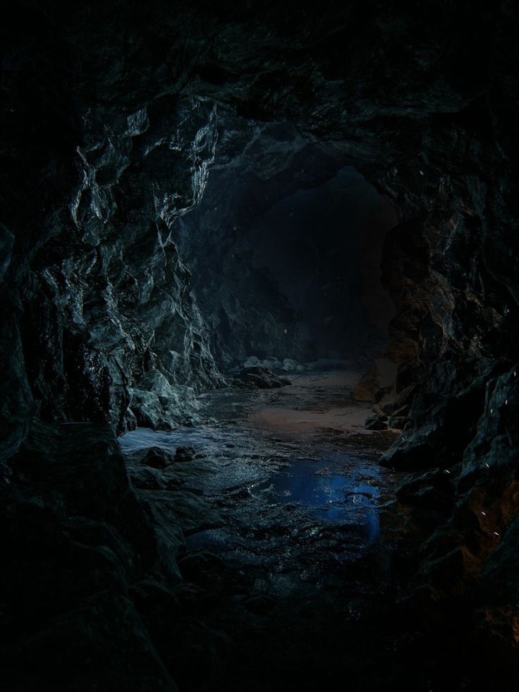 a dark cave filled with lots of water next to a light at the end of it