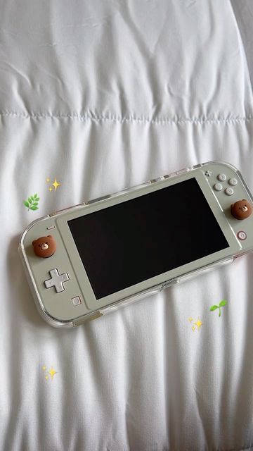 a nintendo wii game controller laying on top of a bed