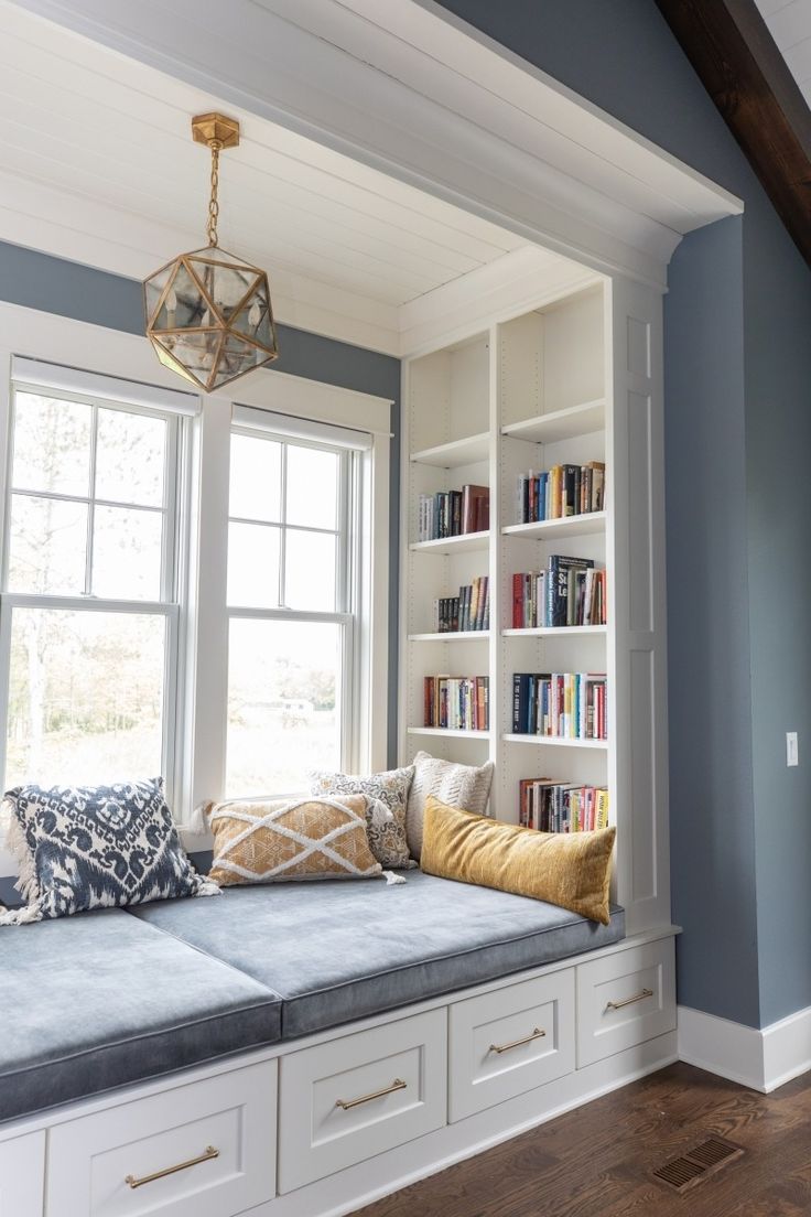 a window seat with bookshelves in the background