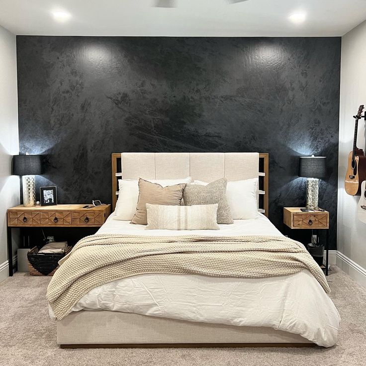 a bedroom with black walls and white bedding