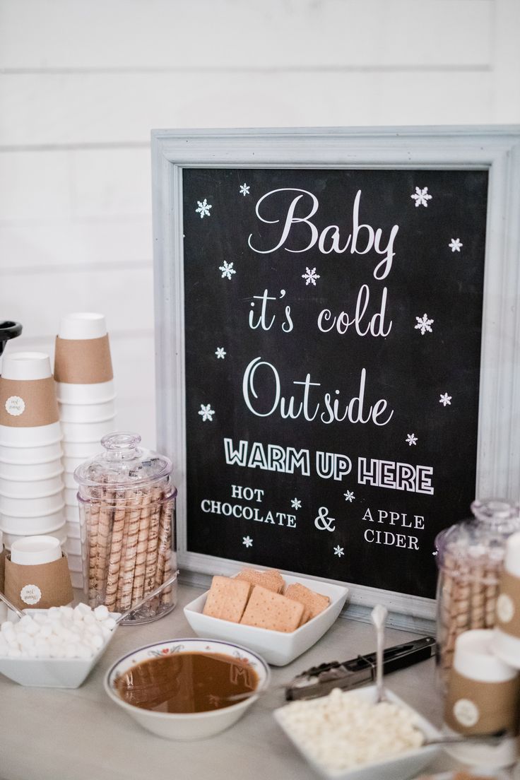 baby it's cold outside warm up here sign surrounded by desserts and snacks