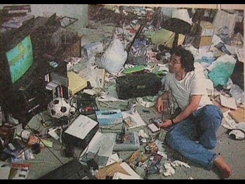 a man sitting on the floor surrounded by trash