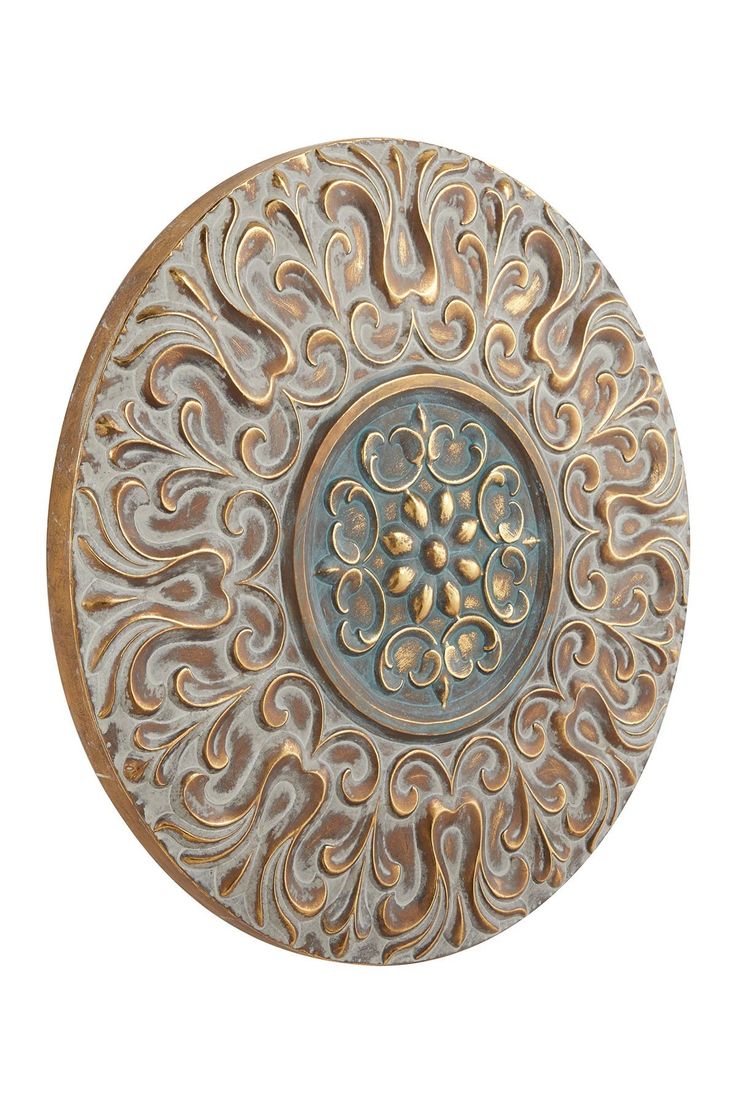 an ornate metal plate on a white background