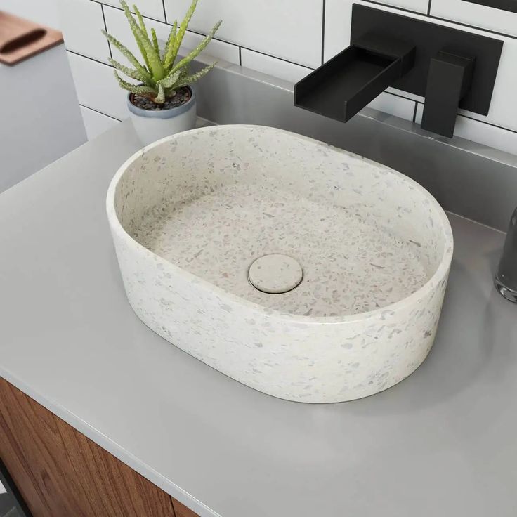 a white sink sitting on top of a bathroom counter