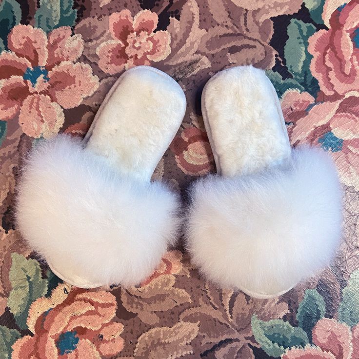 You can walk on clouds all winter in our 100% alpaca fur, open-toe slippers made in Peru. Featuring all-natural fluffy white fur on the outer strap and insole, and a durable suede bottom sole. Alpacas live in their natural habitat in the Andes mountains of Peru and are a prized animal to the people and their culture. When the animals reach the end of their natural lifecycle, the fleece can be used to make ethically produced and cruelty free products. Alpaca fiber is hypo-allergenic and easy to c Soft Open Toe Indoor Slippers, White Open Toe Indoor Slippers, Fluffy Faux Fur Slippers For Winter, Fluffy Faux Fur Slip-on Slippers, Cozy White Slippers With Plush Lining, Fluffy White Indoor Slippers, Fluffy Faux Fur Open Toe Slippers, White Fluffy Indoor Slippers, Soft Sheepskin Slippers With Round Toe