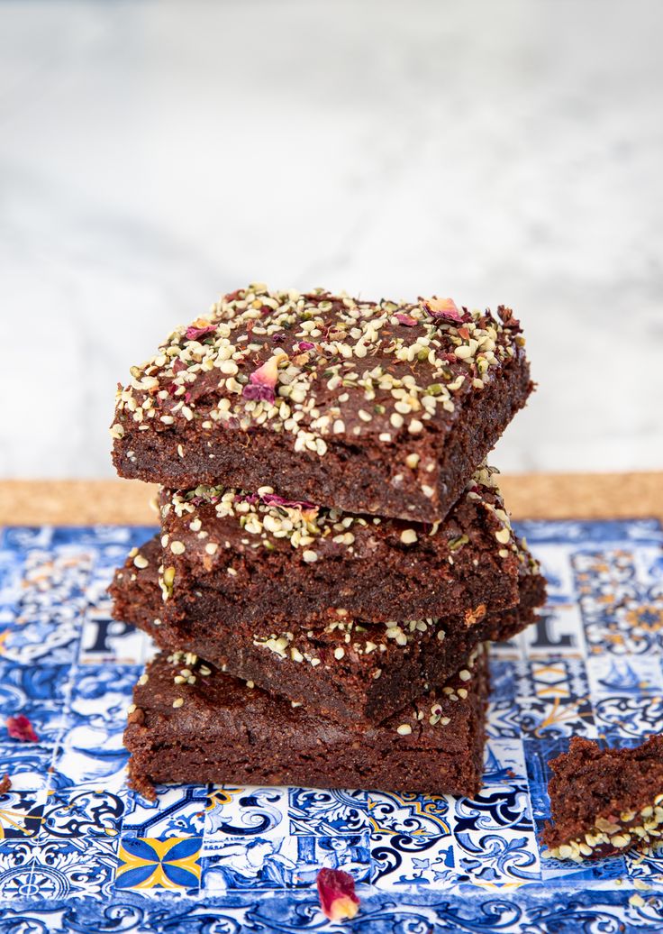 a stack of brownies sitting on top of a blue and white tile countertop