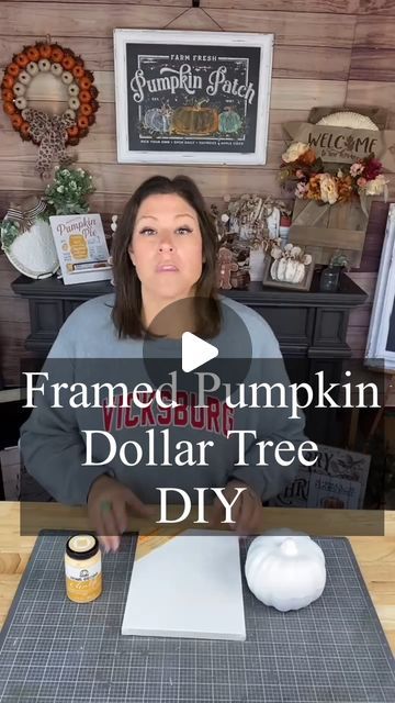 a woman sitting at a table in front of a pumpkin and dollar tree diy