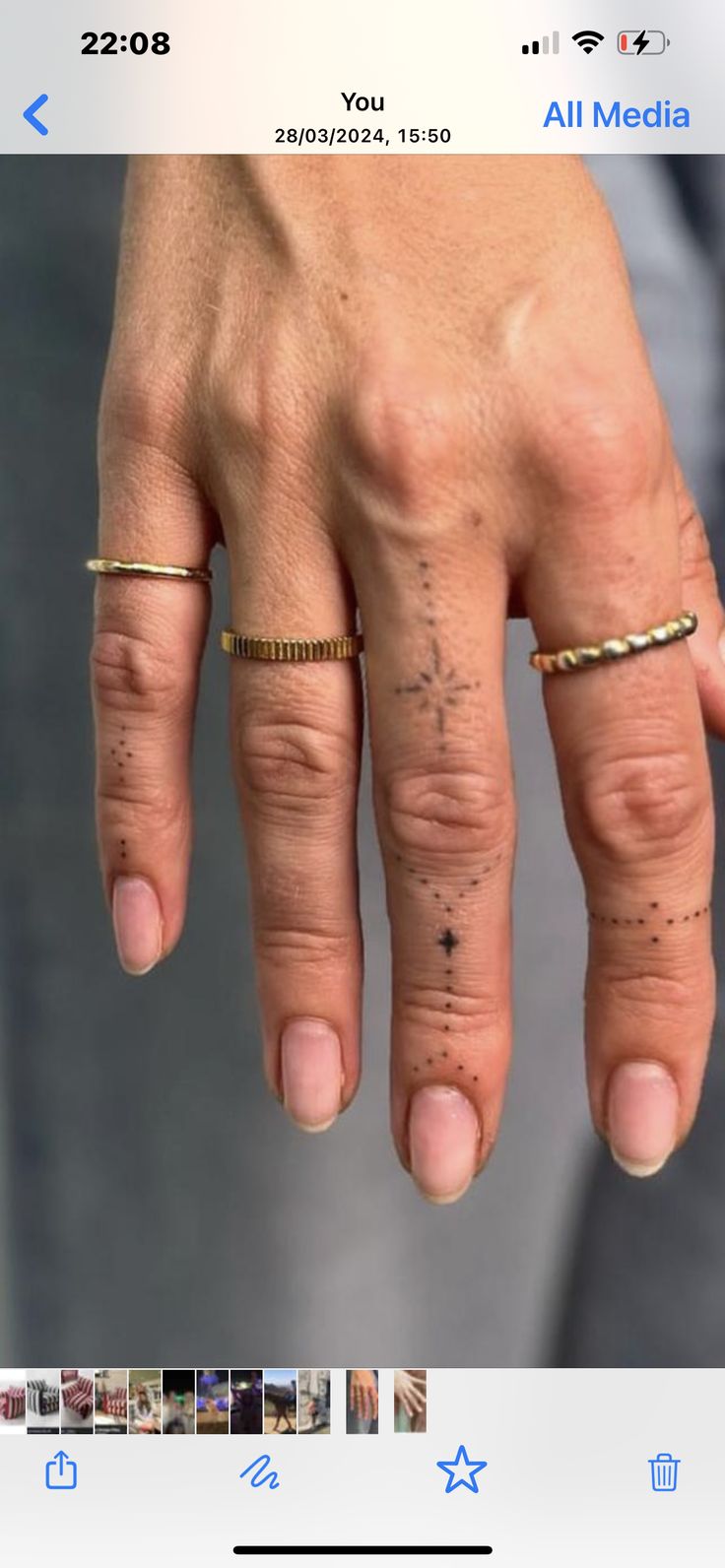 a person's hand with two rings on it and one ring in the middle