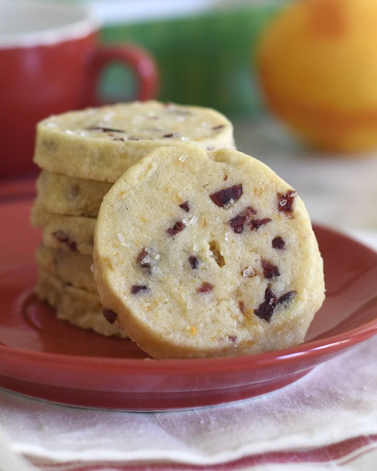 three cookies sitting on top of a red plate