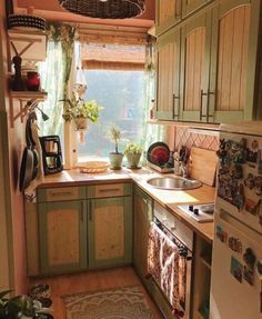 a kitchen with green cabinets and white appliances