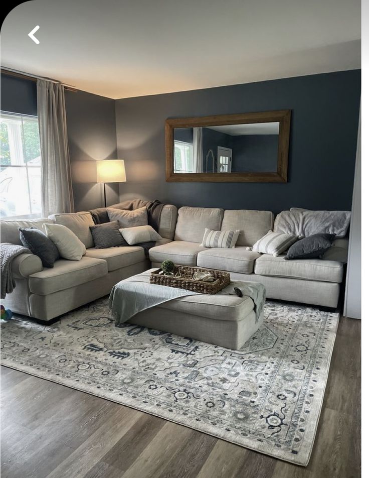 a living room filled with furniture and a large rug