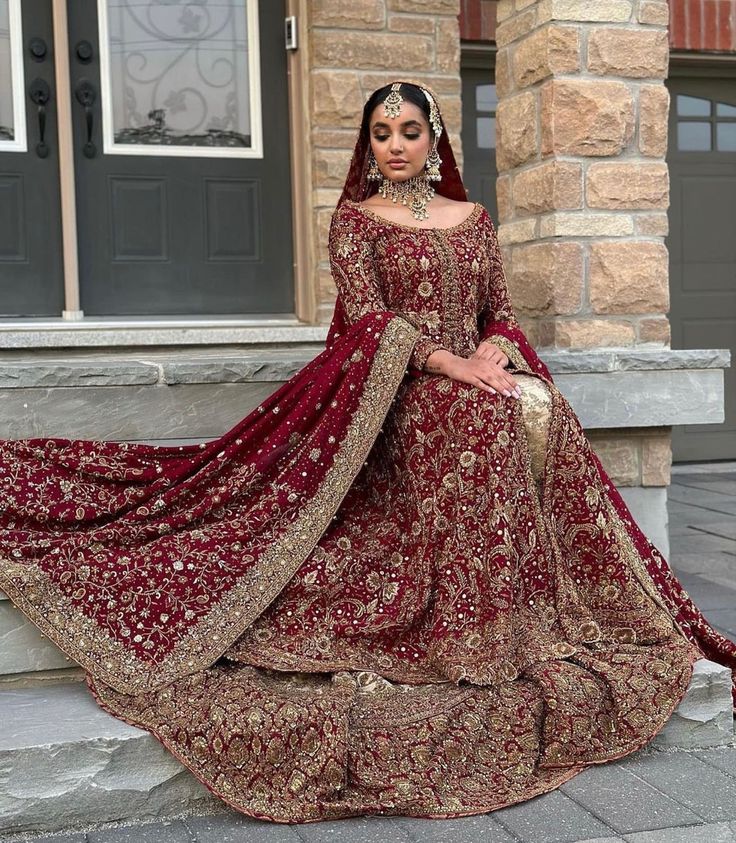 a woman in a red and gold wedding gown