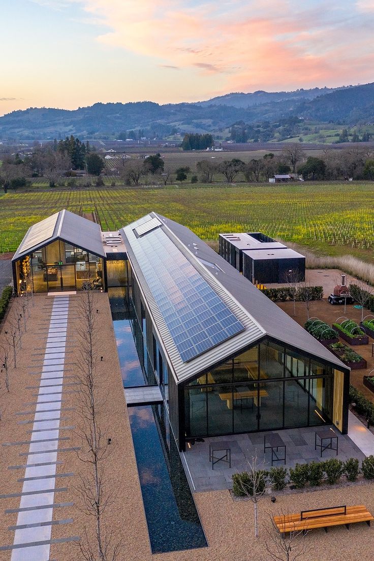 an aerial view of a house with solar panels on the roof