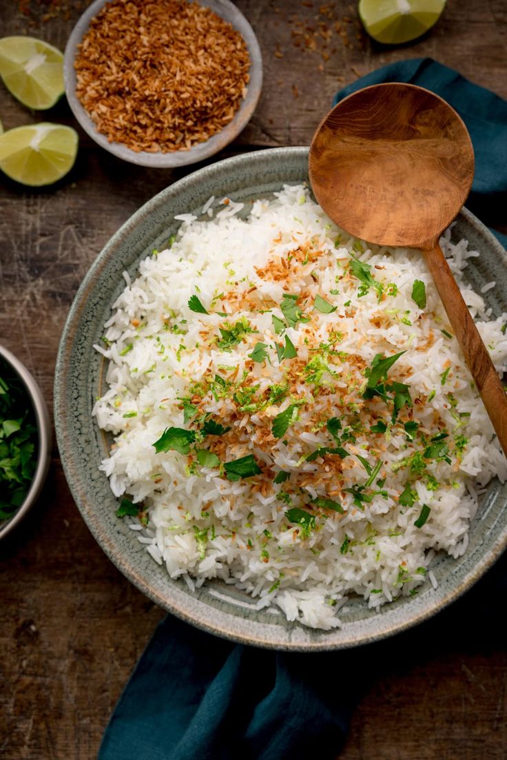 a bowl filled with white rice and garnished with herbs