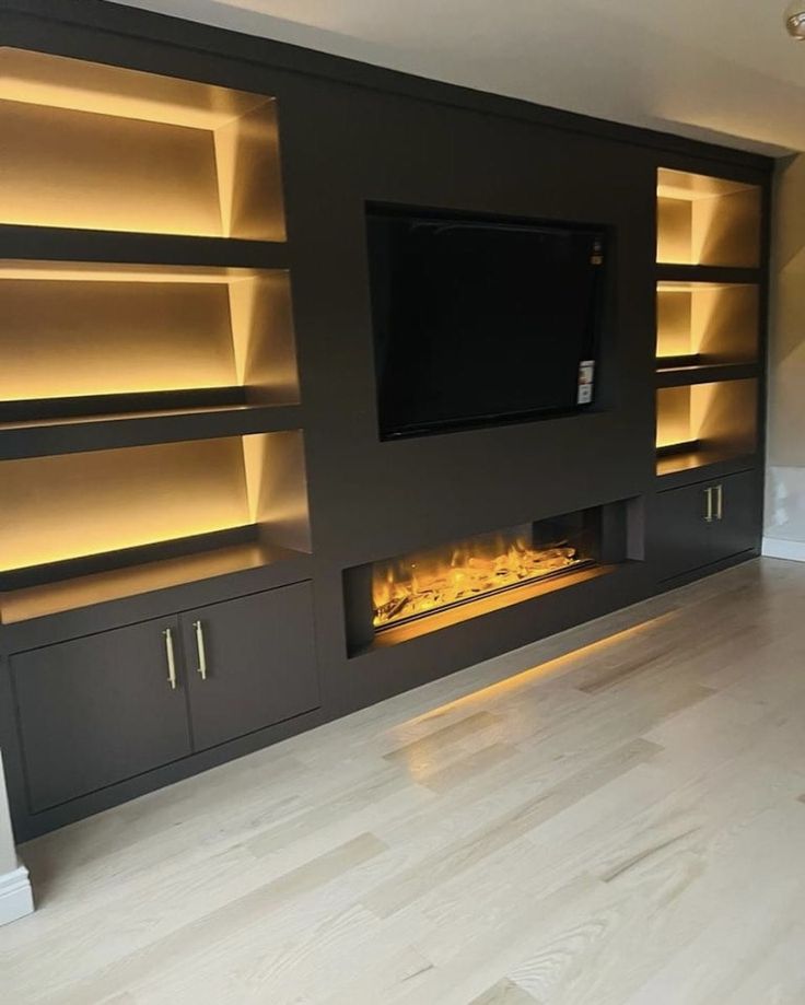 an entertainment center with built - in fireplace and shelves