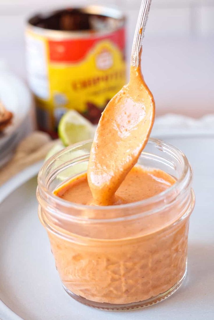 a spoon full of peanut butter on top of a plate