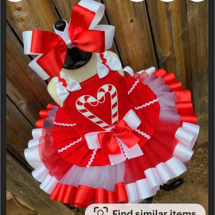 a red and white valentine's day outfit with candy canes on the front