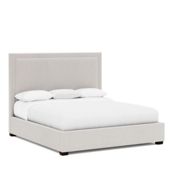 a bed with white linens and pillows on top of the headboard, in front of a white background