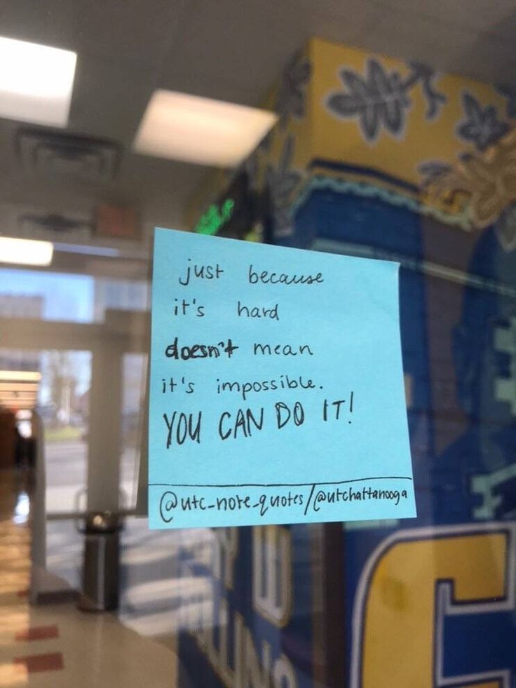 a post it note attached to a glass door