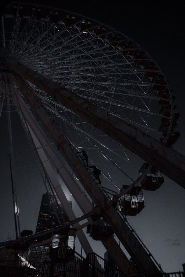 the ferris wheel is lit up at night