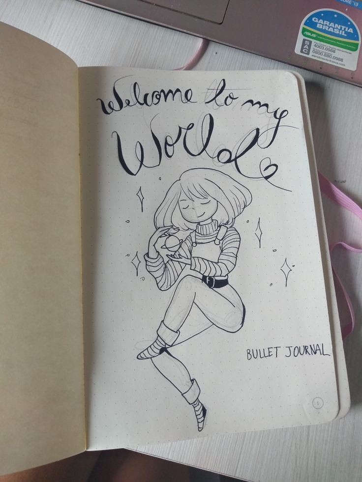 an open notebook with a drawing of a woman holding a baby in her arms and the words welcome to my world written on it