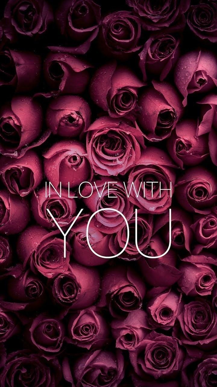 the words in love with you are surrounded by pink roses on a black background that says,