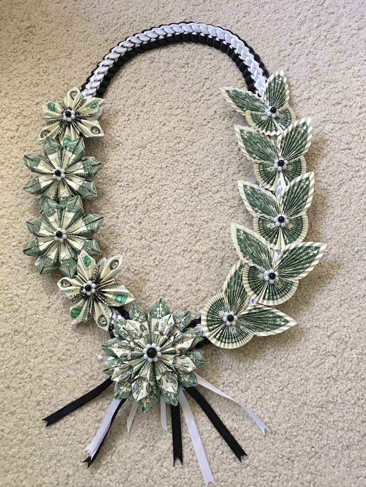 a necklace made out of dollar bills and flowers