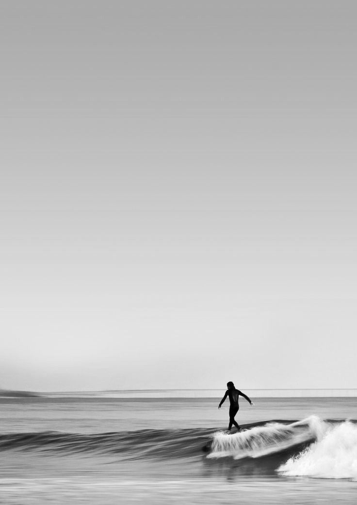 a person riding a wave on top of a surfboard