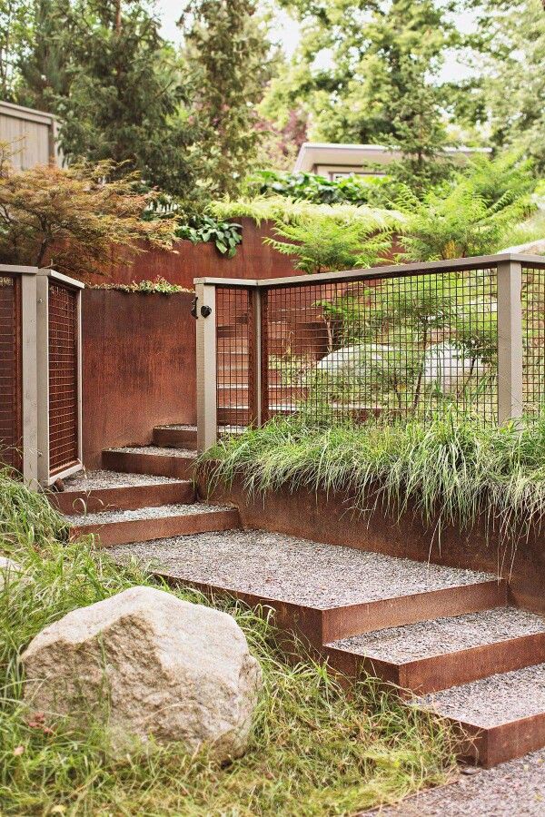 the steps are made out of concrete and have grass growing on them, along with some rocks