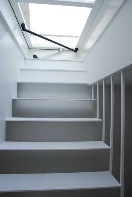 some white stairs leading up to a skylight