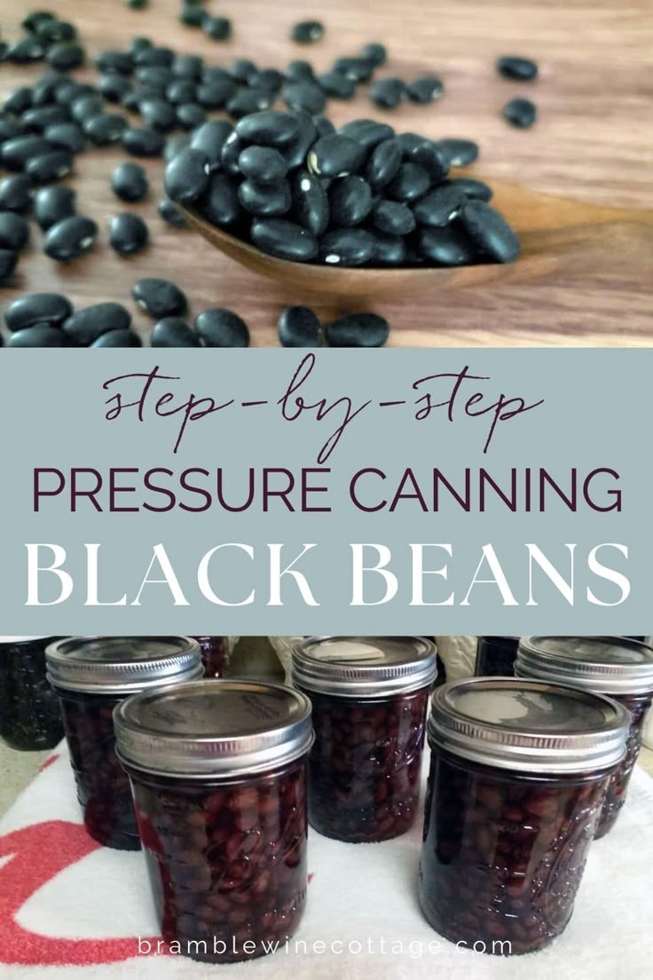 four jars filled with black beans sitting on top of a table