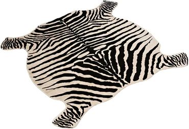 a zebra rug is laying on the floor with its back legs spread out and it's eyes closed