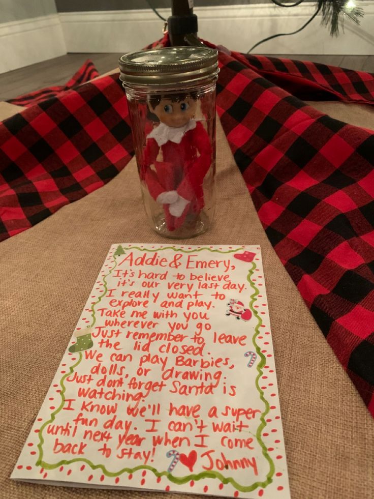 a mason jar filled with candy sitting on top of a table next to a note