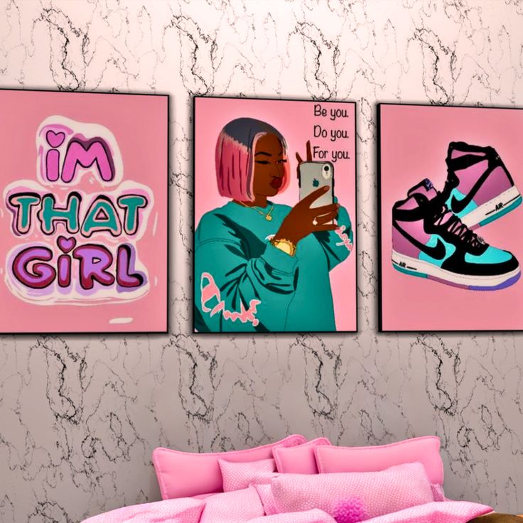 two pink posters on the wall above a bed