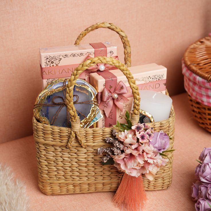 a wicker basket filled with lots of different types of items next to flowers and candles