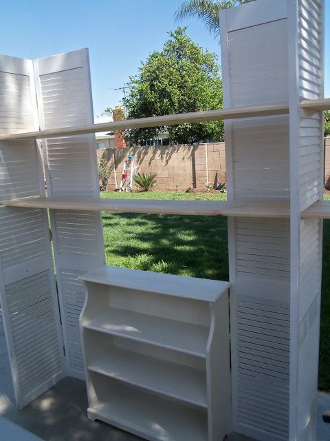 there are several white shelves in the yard