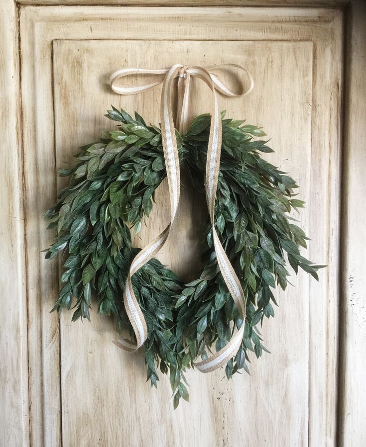 a wreath hanging on the front door of a house