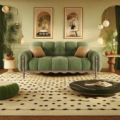 a living room filled with green furniture and decor on top of a white carpeted floor