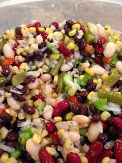 a bowl filled with beans, corn and green peppers