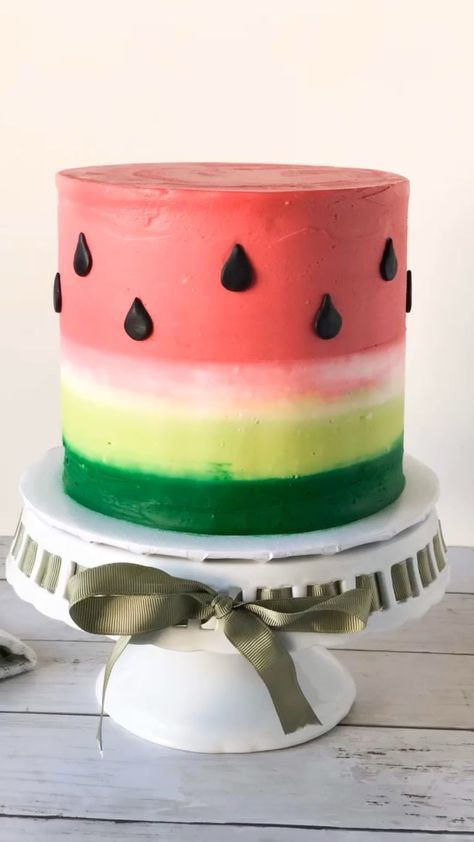 a watermelon cake with black dots on top