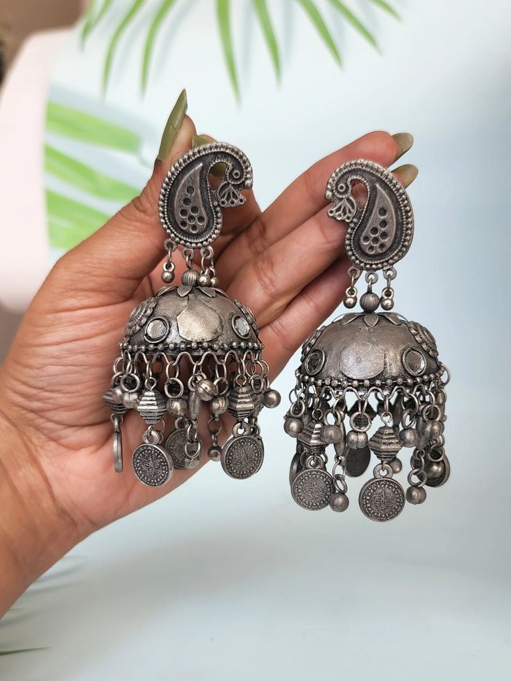 Add ethnicity and charm to your beautiful personality with these uniquely designed black metal earrings. The intricate work gives combo set a very appealing and eye catching look.Pair them up with any semi formal or casual attire and win compliments for your unique choice! Materials: German Silver, oxidised silver, Alpaca silver, white metal Style: Boho & hippie Cheap Oxidized Round Earrings, Cheap Oxidized Metal Earrings, Oxidized Silver Earrings Jhumka Hoop, Luxury Oxidized Finish Dangle Earrings, Luxury Festive Earrings With Oxidized Finish, Cheap Bohemian Metal Jhumkas, Black Metal Earrings, Jhumkas Earrings, Beautiful Personality