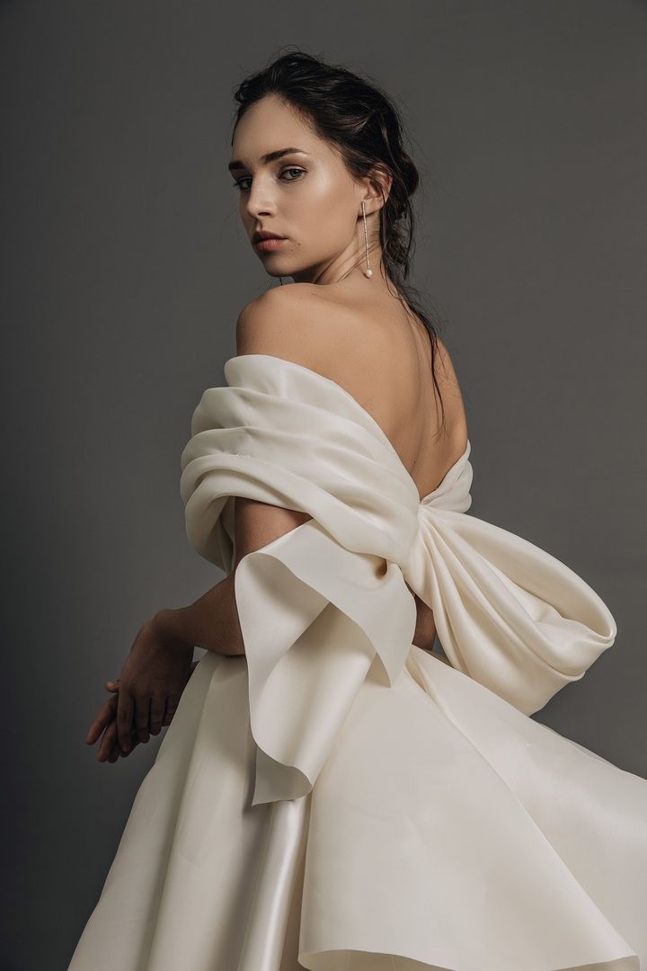 a woman in a white dress posing for the camera