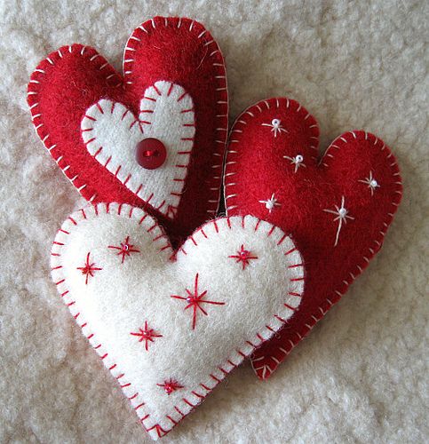 two red and white felt hearts with stars on them