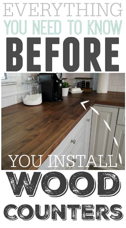 a kitchen counter top with white cabinets and wood