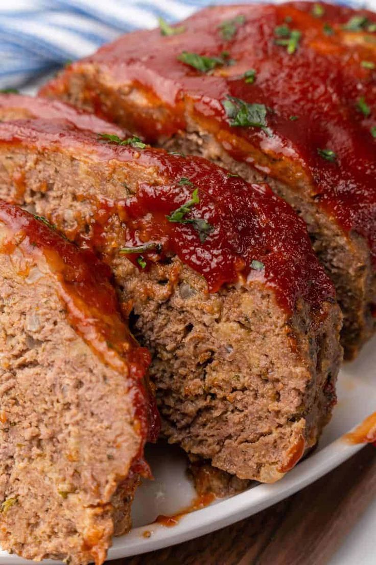 sliced meatloaf on a plate with ketchup