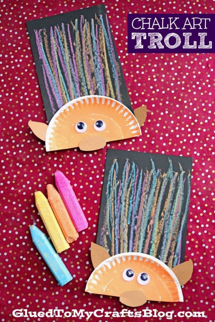 two fish made out of paper and colored crayons